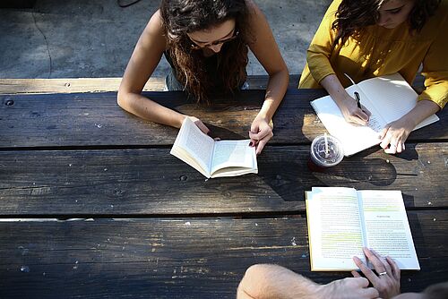 Three students learning outside